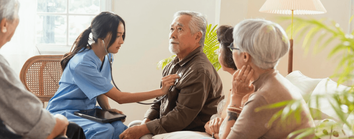 Female nurse caring for an elderly woman at home in Mangalore